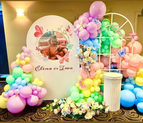 Butterfly themed balloon backdrop with pastel colours and flowers