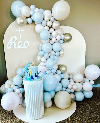 Christening backdrop with soft blue balloons and cross detail