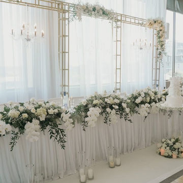 Gold backdrop with fabric and chandeliers