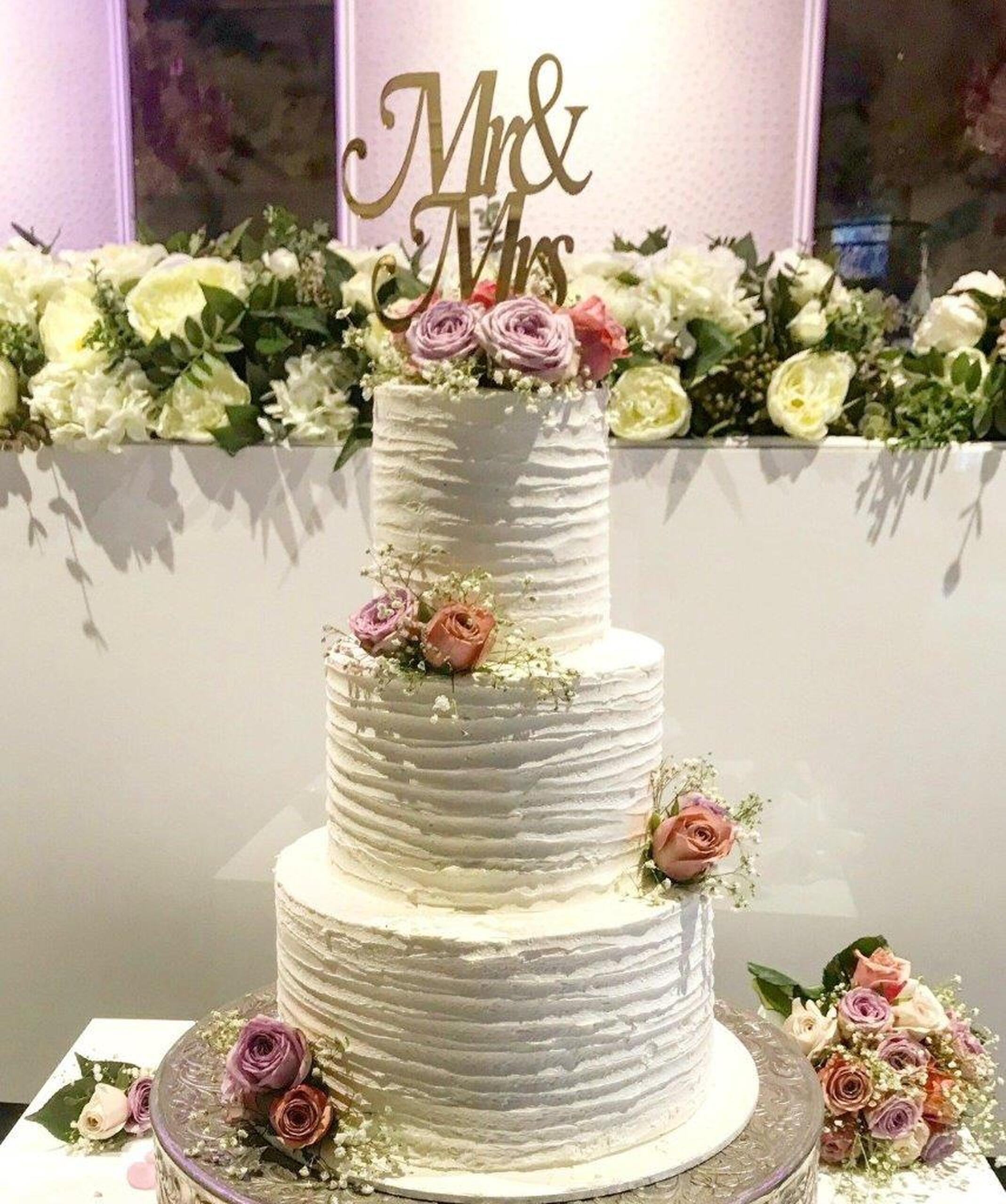 White tiered wedding cake with delicate detailing